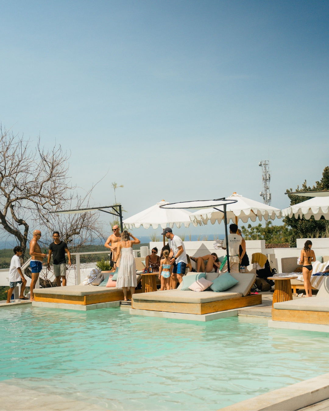 poolside Day Beds with people frolicking by the pool at Karana | Best Day Club in Nusa Lembongan